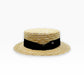 Natural straw boater hat with black ribbon and Sbarià logo pin, crafted in Italy, stylish and artisanal accessory.