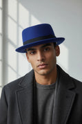 Sbarià waterproof felt pork pie hat in petrol blue with a ribbon bow, crushable and stylish for versatile wear.