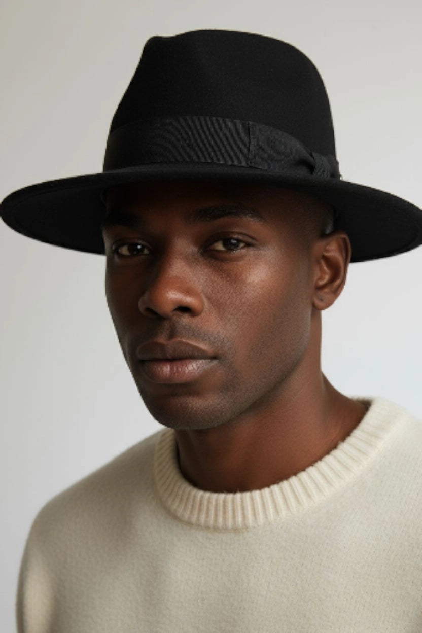 Black felt fedora hat by Sbarià with a ribbon and bow, waterproof and crushable, perfect for stylish outdoor wear.