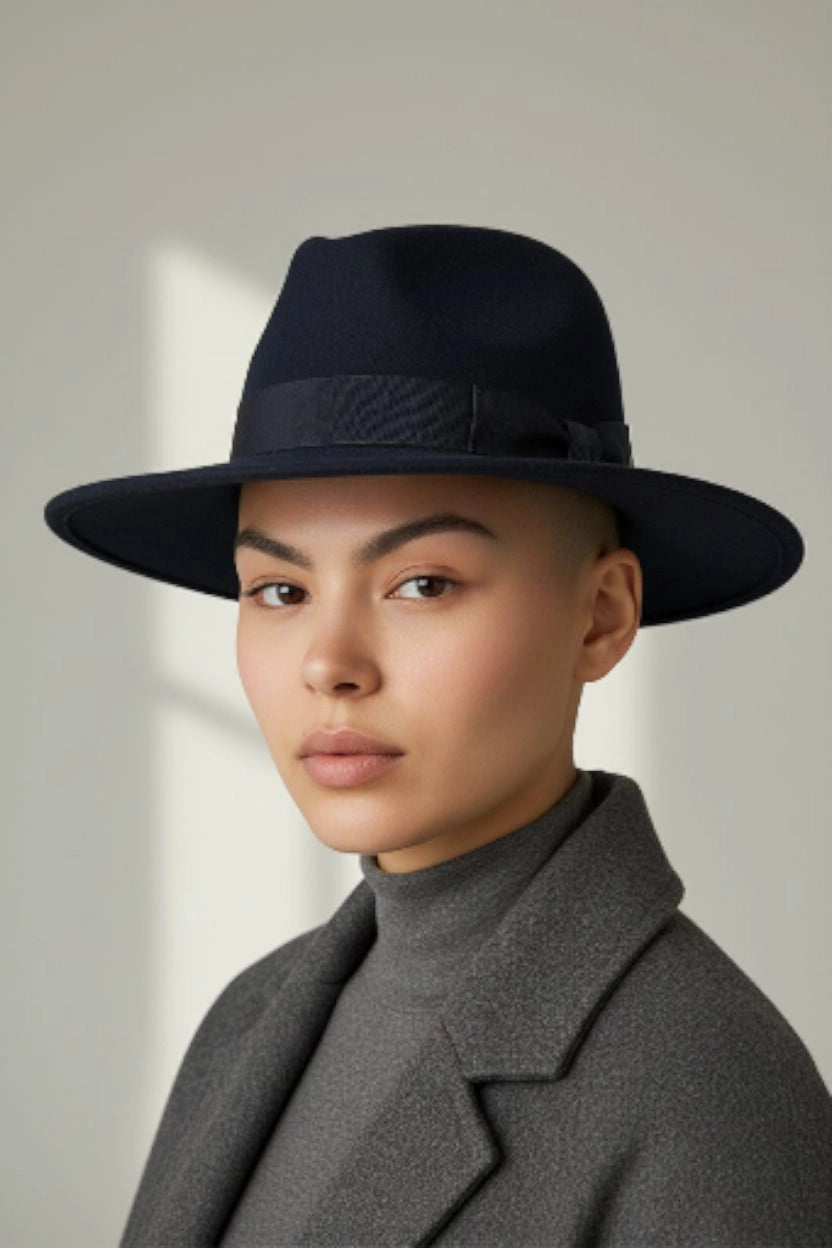 Black felt fedora hat with a ribbon bow by Sbarià, waterproof and crushable, shown on a model.