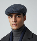 Siciliana wool cap by Sbarià with gray plaid and blue stripes, featuring attached ear cover for warmth and style.