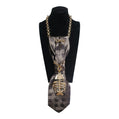 Claudia De Rosa Jewelry Mystic Fish gold cravatta gioiello displayed on a black mannequin, showcasing intricate jewelry design.