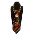 Claudia De Rosa Jewelry Cravatta Gioiello with vibrant red and orange stripes, elegant silk necktie accessory.