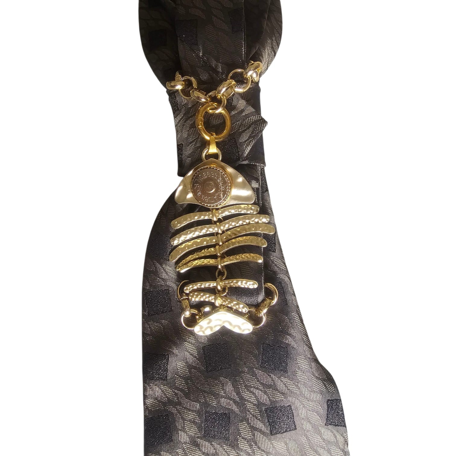 Close-up of Claudia De Rosa Jewelry Mystic Fish Gold Cravatta Gioiello with intricate knot detail and gold finish.