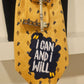 Close-up of CLAUDIA DE ROSA JEWELRY Cravatta Gioiello with detailed patch design featuring the phrase "I can and I will".