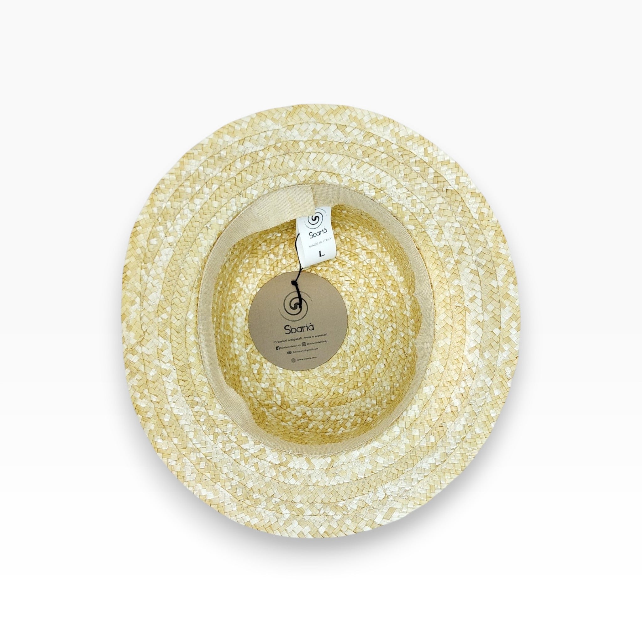 Interior view of Sbarià natural straw boater hat with spiral logo tag, showcasing handcrafted Italian craftsmanship.
