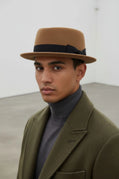 Sbarià pork pie hat in waterproof, crushable felted beaver wool with a ribbon and bow, stylish and durable headwear.