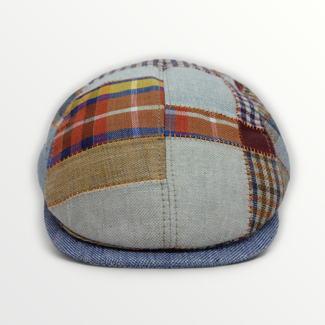 Coppola Primavera/Estate patchwork cap made of linen and cotton with colorful stitched panels and a classic brim.