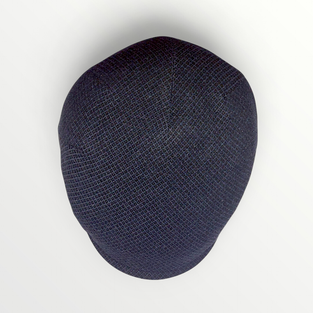 Blue and black wool Coppola hat with small diamond pattern from Autunno/Inverno collection, stylish and warm for winter wear.