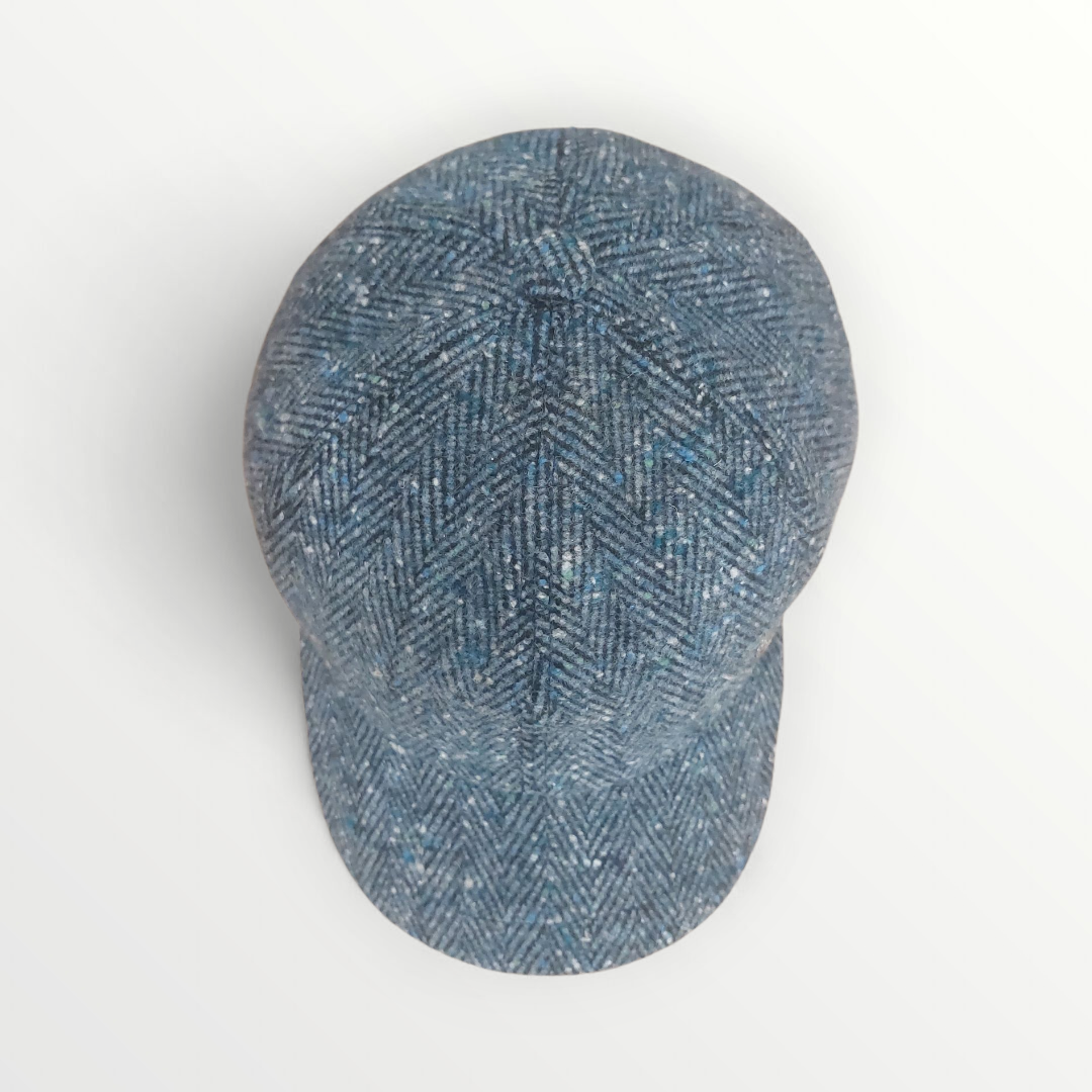 Sbarià baseball cap in blue herringbone wool, showcasing a stylish and cozy berretto design with a curved brim.