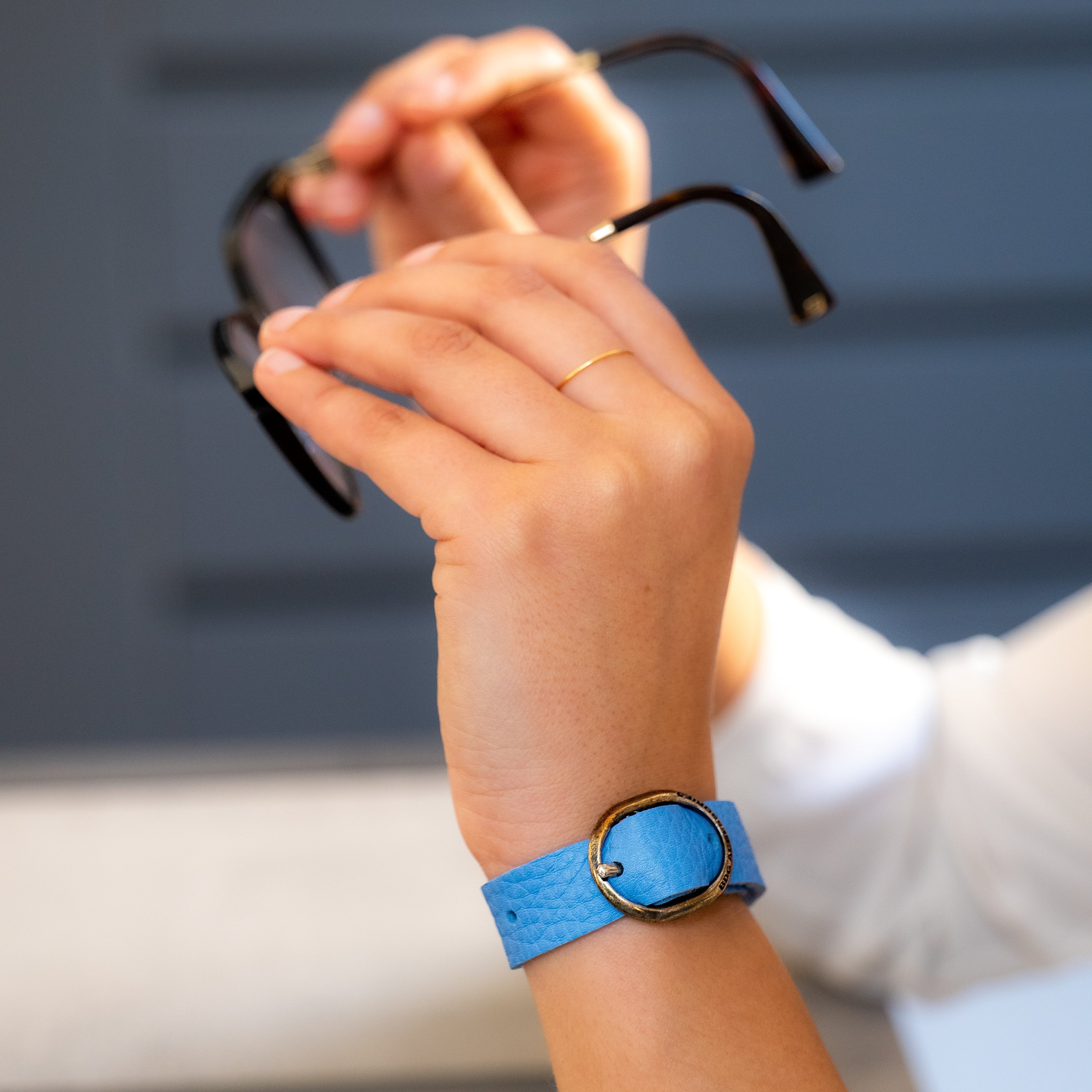 BDG Accessories elegant ellipse bracelet in red and light blue with a sleek, stylish design on a white background.
