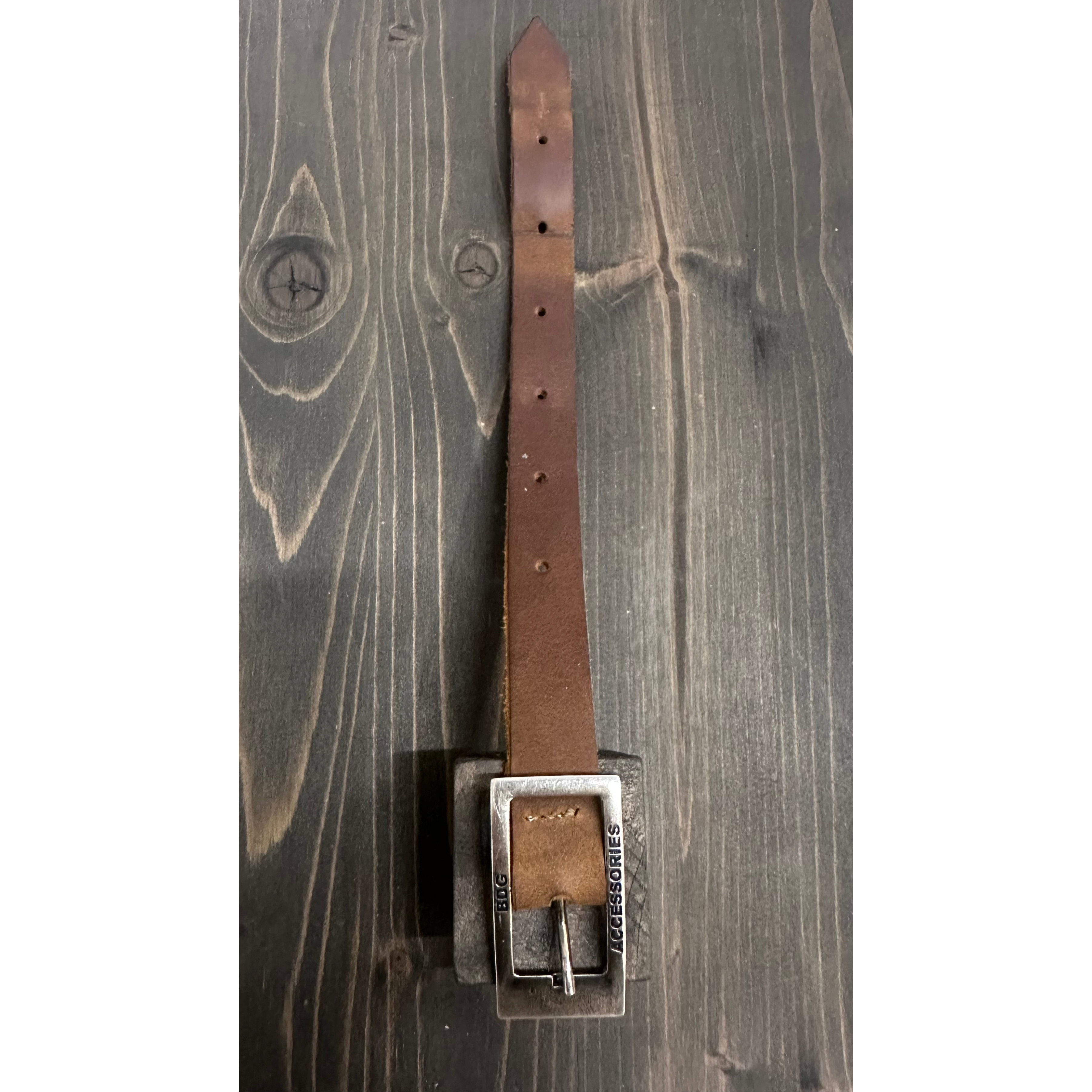 BDG Accessories brown leather old-style bracelet with a simple, rustic design, laid flat on a white background.