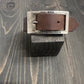 BDG Accessories leather bracelet in old style resting on a wooden block, showcasing its vintage design and craftsmanship.