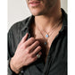 Silver enamel necklace with vintage 1950s Dolce Vita style from BDG Accessories, worn on a man's hand.