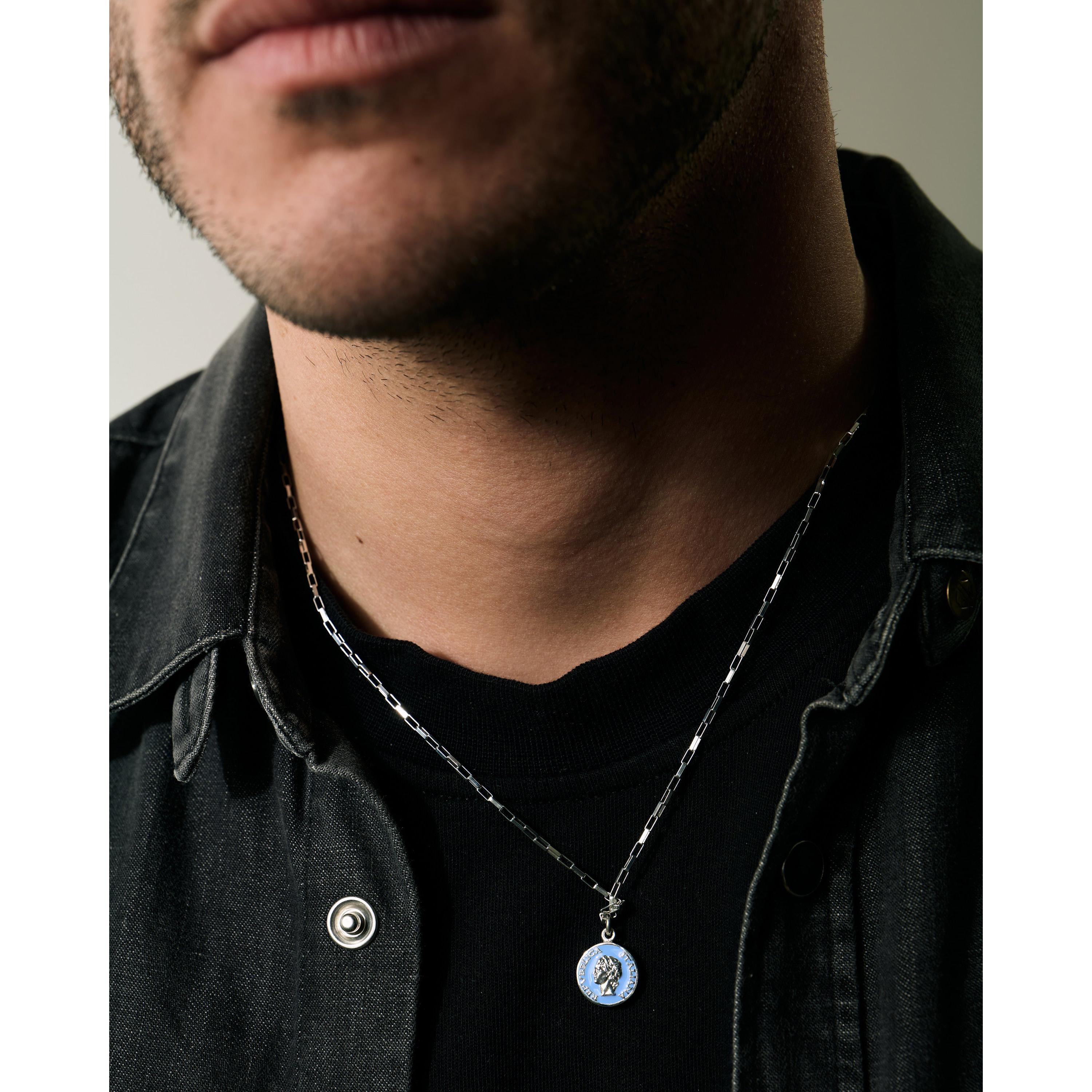Silver enamel necklace inspired by 1950s vintage style, worn by a man, featuring bold design and classic charm.