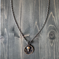 Silver and bronze pirate-themed necklace featuring a skull pendant and black sails design by BDG Accessories.