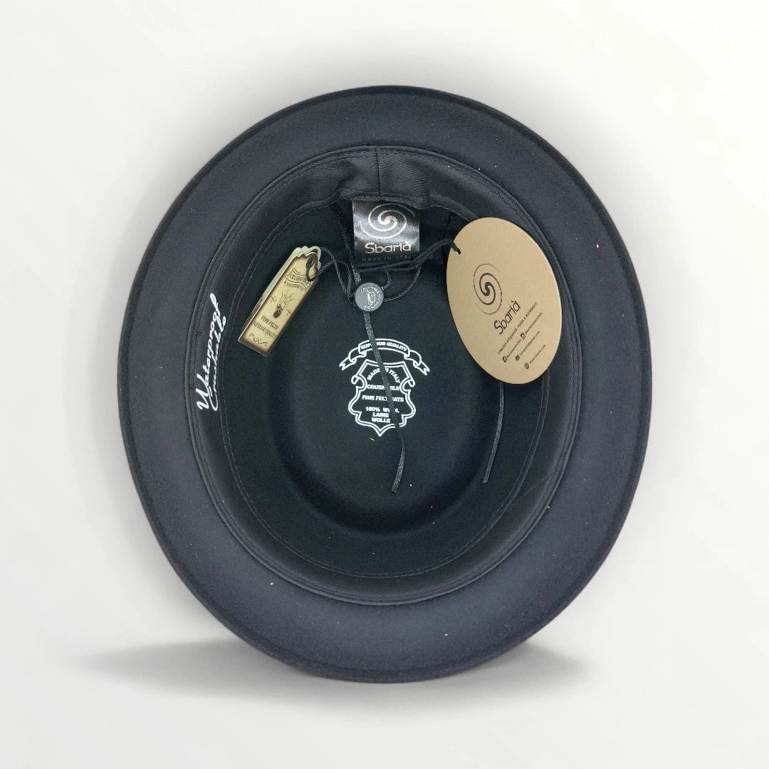 Black felt pork pie hat by Sbarià with a ribbon and bow, waterproof and crushable, stylish and durable headwear accessory.