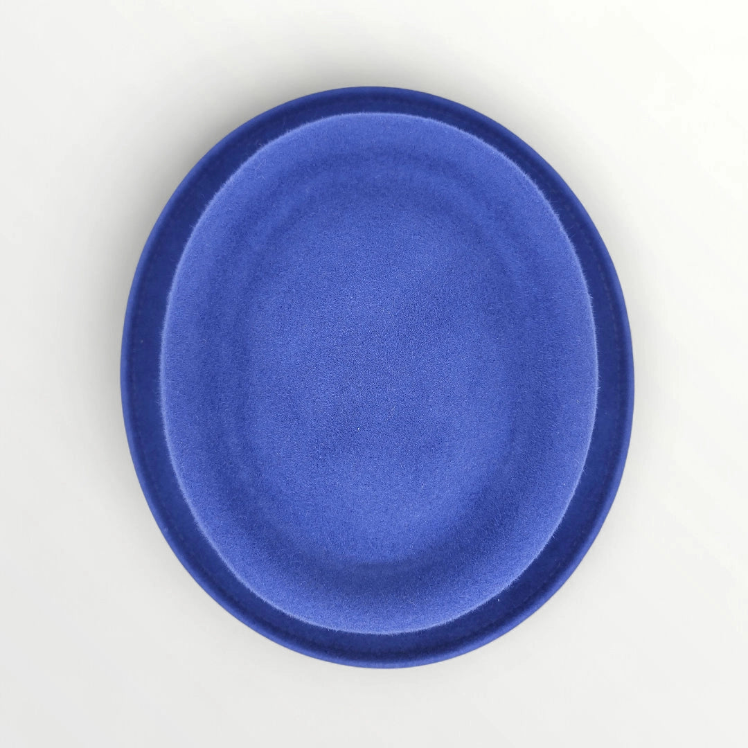 Sbarià waterproof wool felt pork pie hat in petrol blue with a ribbon and bow, featuring a crushable and water-resistant design.