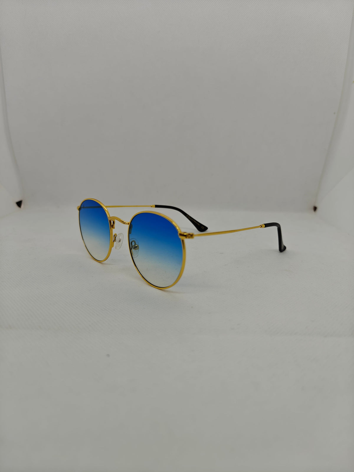 Occhiali da sole rotondi Sbarià con montatura in alpacca dorata e lenti sfumate blu, stile vintage anni 70