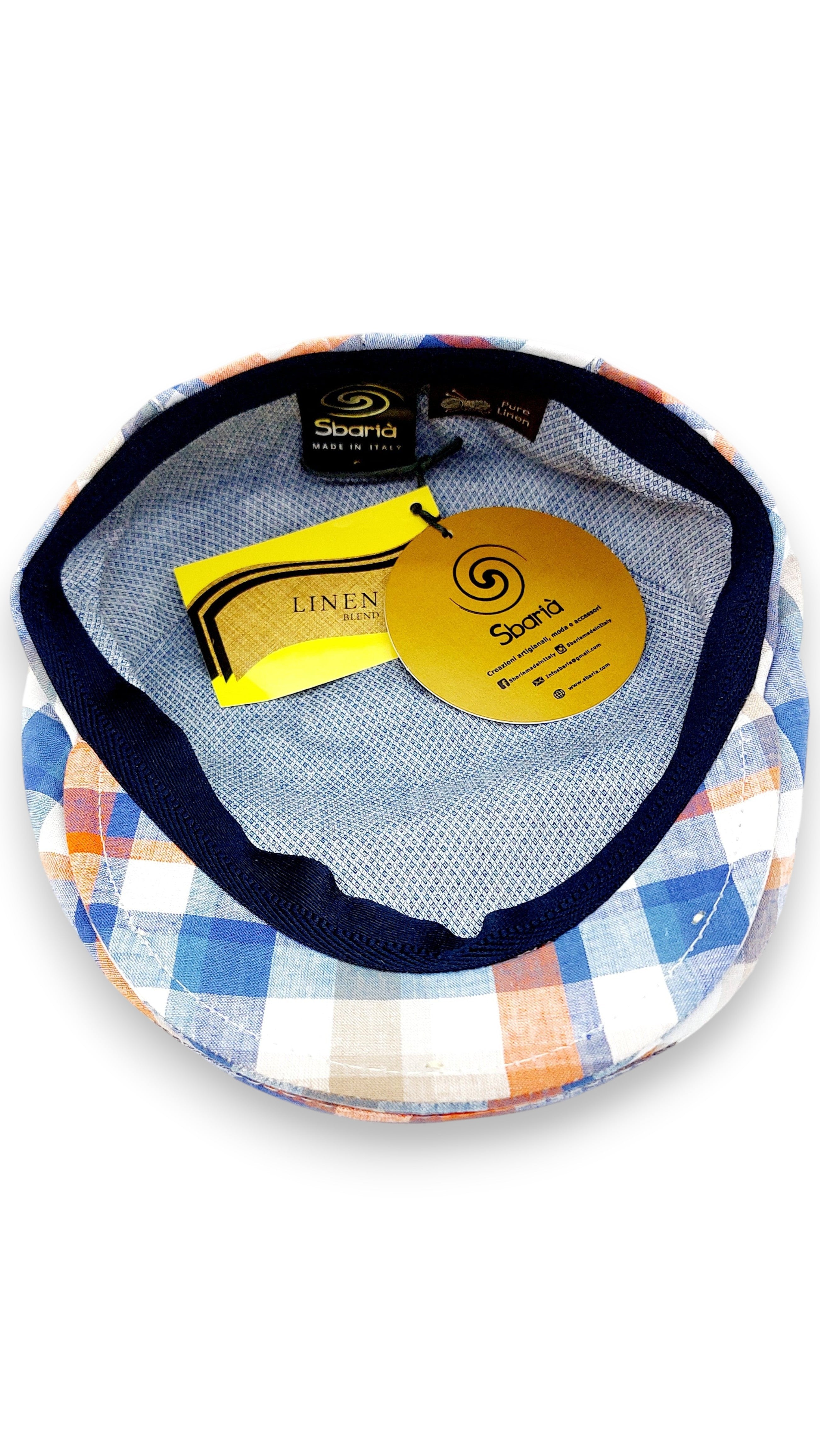 Sbarià London multicolor madras flat cap in linen and cotton blend. Features a blue, orange, beige, and white plaid pattern and artisanal Italian craftsmanship.